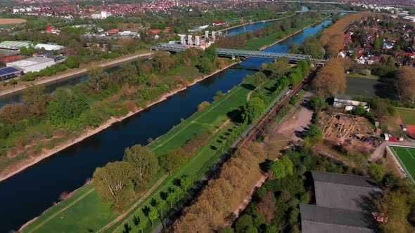 Top view of the embankment of the Neckar River. Bridges, green grass and trees. Mannheim. Germany. alt