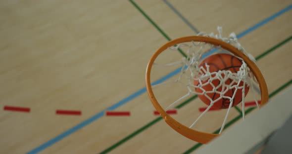 Overhead view of african american male basketball player scoring goal against diverse players alt