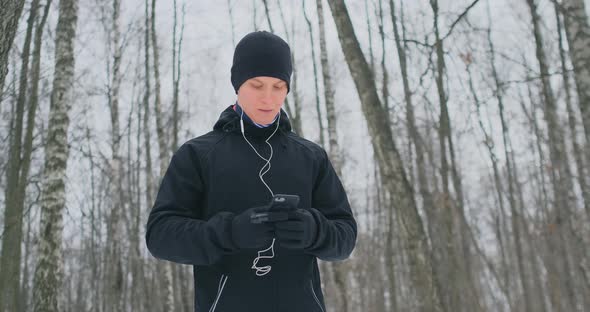 A Young Man in a Black Hammer in the Winter Is Preparing To Jog in the Park Includes an Application alt
