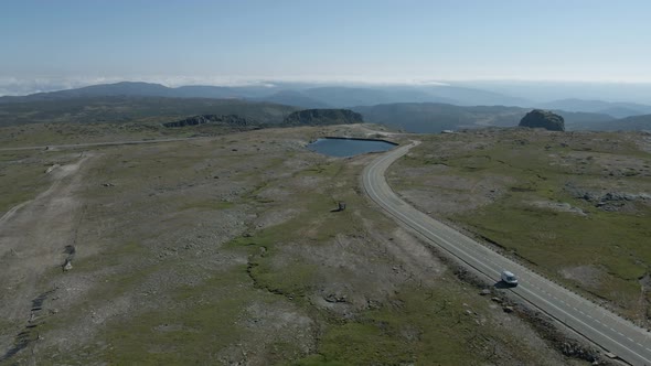 Isolated car driving on road at Serra da Estrela, Portugal. Aerial panoramic view alt