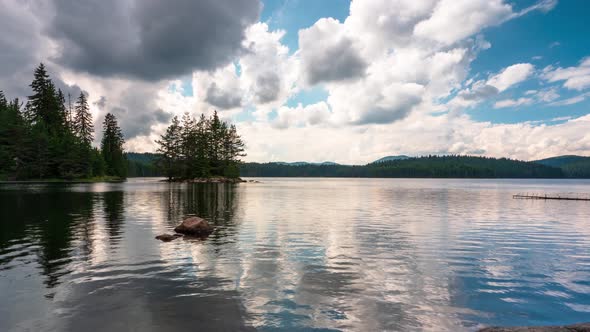 Summer view of а mountain lake and moving fluffy clouds  alt