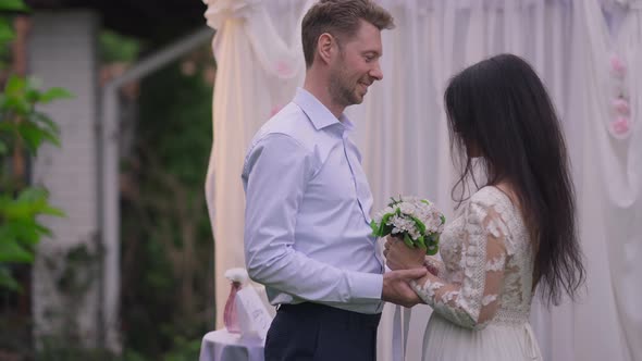 Side View of Slim Confident Beautiful Middle Eastern Bride with Wedding Bouquet Walking to Loving alt