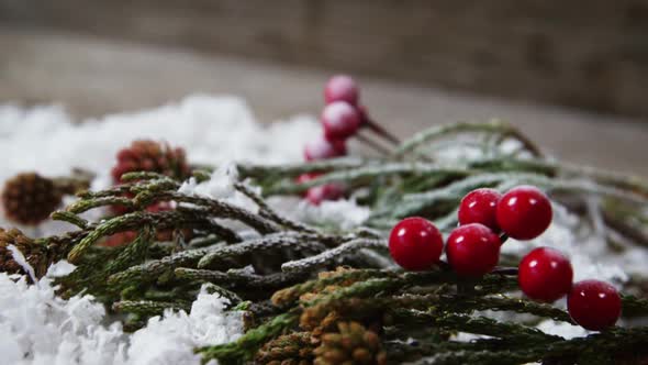 Pine cone and red cherries with fake snow alt