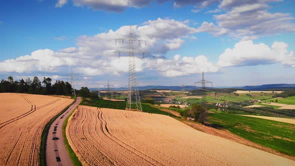Electric power transmission towers at countryside alt