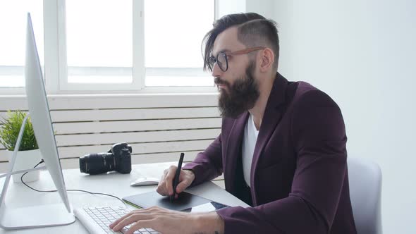 Concept of Graphic Design and Professional Photography. Young Male Graphic Designer, Photographer alt