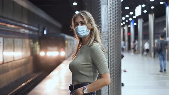 Passengers Mask Wait Train Metro Coronavirus. Woman Stand on Station Covid-19. alt