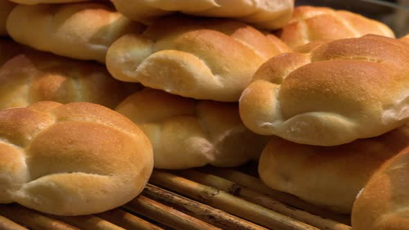 Closeup on a Pile of Bread Rolls on a Shelf in a Store alt