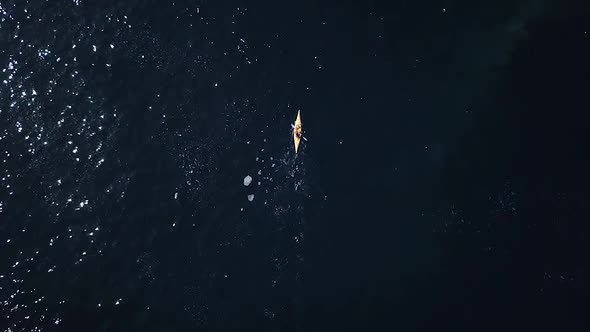 Flying above a tiny kayak on the huge blue sea