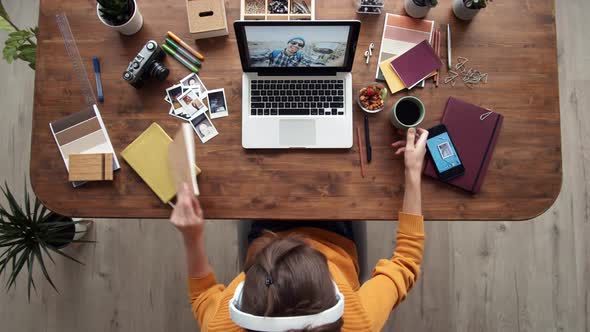 Woman Enjoying Music while Working alt