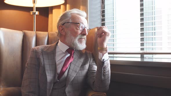 Toned Retro Styled Portrait of Businessman Sitting in Armchair at Office alt