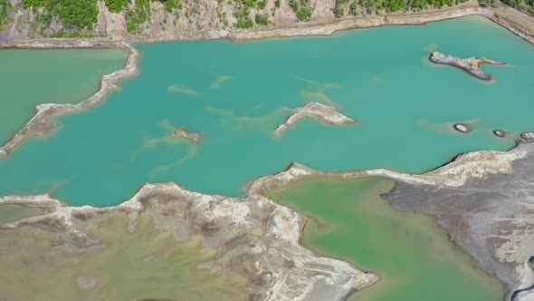 Drone View of the Turquoise Lake Formed As a Result of Mining Waste alt