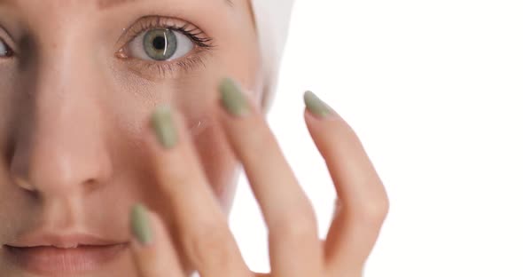 Closeup of a Part of European Young Woman's Face with a Hair Drying Towel on Her Head Applies alt