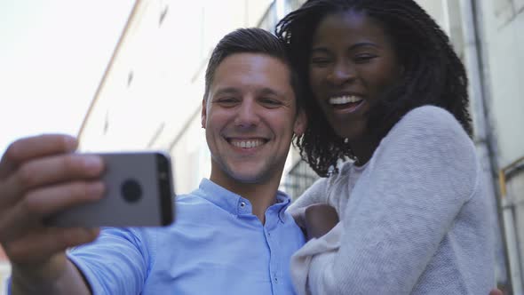 Happy Young Multiracial Couple Posing for Selfie Outdoor alt