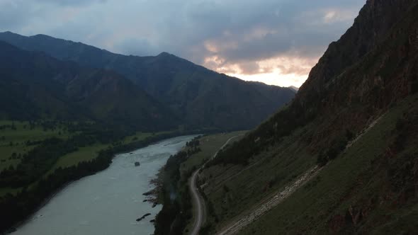 Katun river and road in valley of Altai at sunset time with dramatic sky