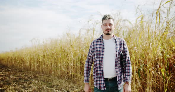 Young Farmer Walk on Field Agriculture alt