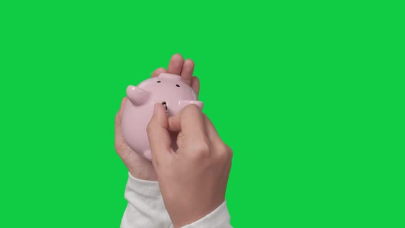 Saving money concept, Asian woman hand putting money coin into piggy bank alt