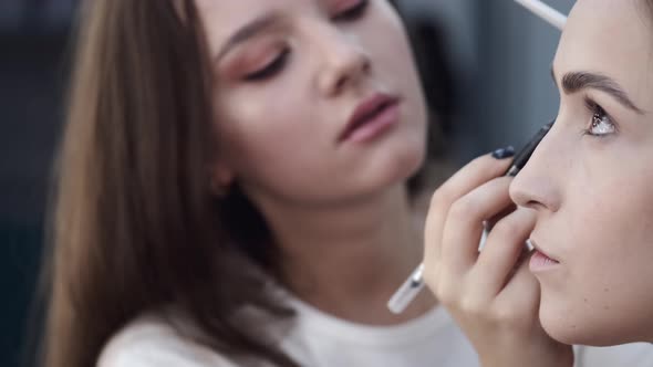 Portrait of Makeup Artist and Client While Doing Makeup alt