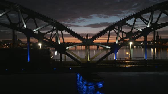 Cargo Train Going Over the Bridge During Epic Sunset in Riga Latvia alt