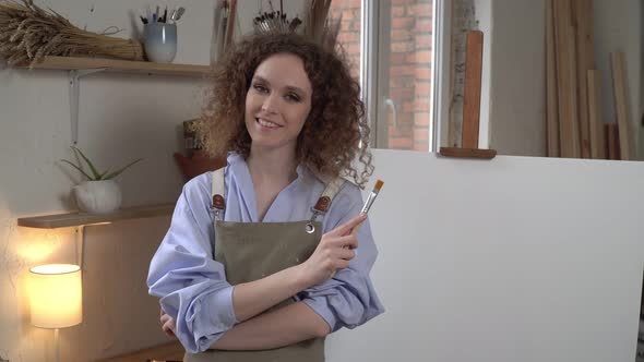 Young Attractive Woman Artist in the Workshop alt