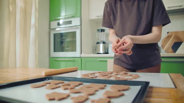 Young Woman in Brown Tshirt Backing Cookies on a Silicon Mat at Home Kitchen