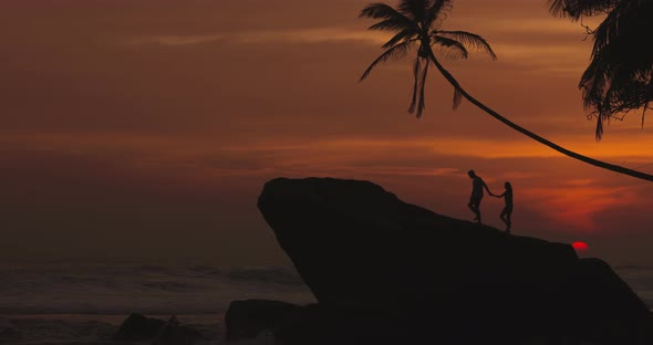 Lovely Couple on Rocks in Sea