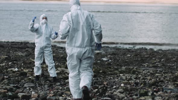 Forensic scientist examining sample at river bank