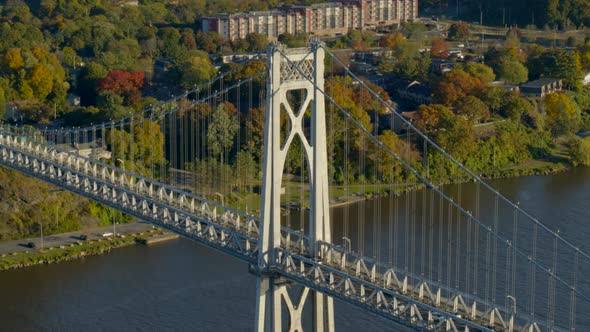 Aerial of Mid-Hudson Bridge and town amidst autumn trees at distance alt