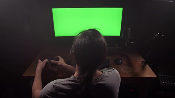 A Man in Headphones Looks at the Green Screen of the Monitor Removes the Headphones Looks at the alt
