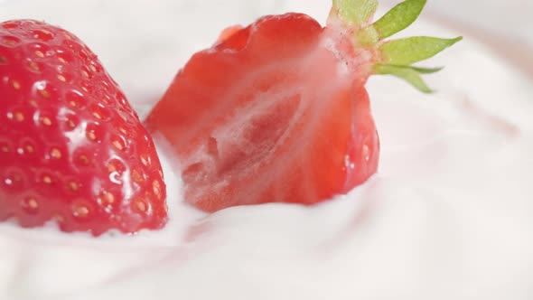 Fresh strawberries dipped in yogurt. Close up. Circular motion of the camera