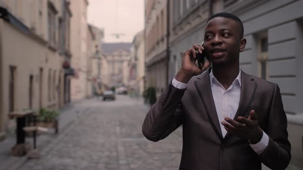 African Man in Suit Talking on Mobile