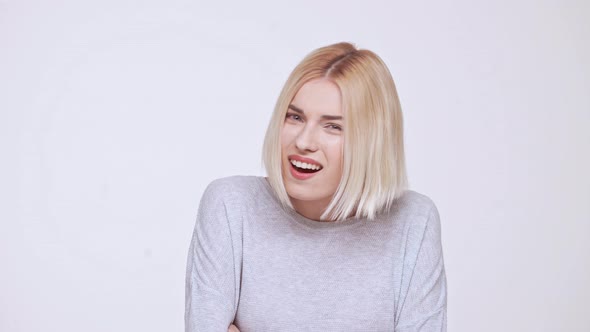 Young Beautiful Critical Blond Girl Pretending She Heard Nothing White Background alt