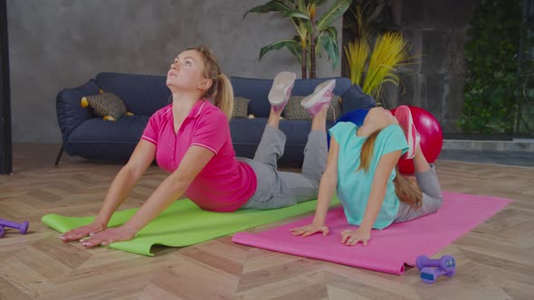 Mom and Daughter Performing King Cobra Exercise at Home alt