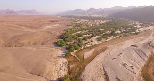 Dry Riverbed Next to Desert