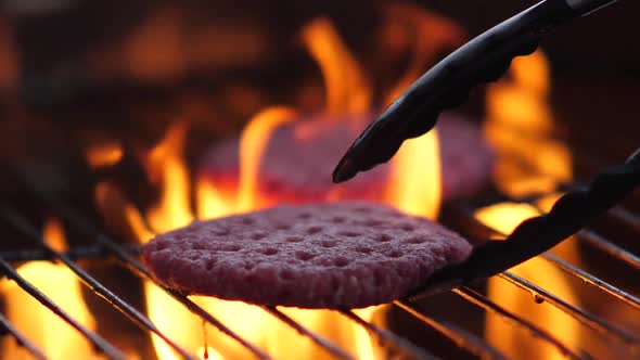 Delicious fresh hamburgers on the grill in slow motion