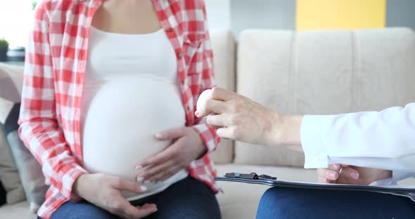 Doctor Prescribes Medicines or Vitamins to Pregnant Woman alt