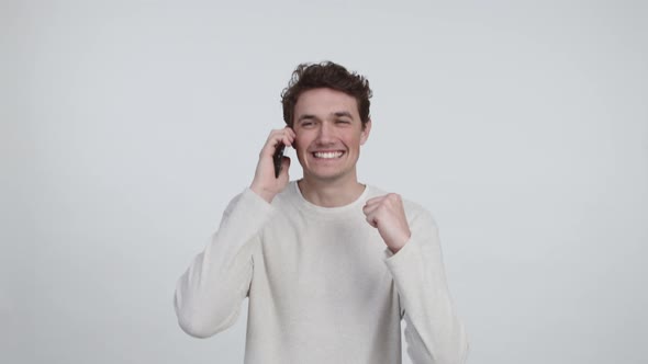 Caucasian Male Receiving Good News via Phone Call