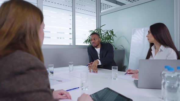 Black Manager Discussing Strategy with Colleagues at Business Meeting alt