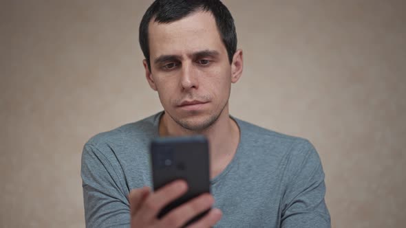 Surprised Man Looking at Mobile Phone alt