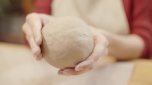 Hands of Unrecognizable Woman Shaping Clay Vessel by Pinching alt