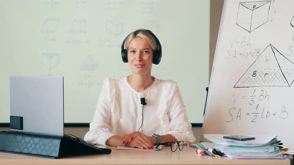 A Woman in Headphones Is Teaching an Online Class. Distant Studying, Remote Education, Online Lesson alt