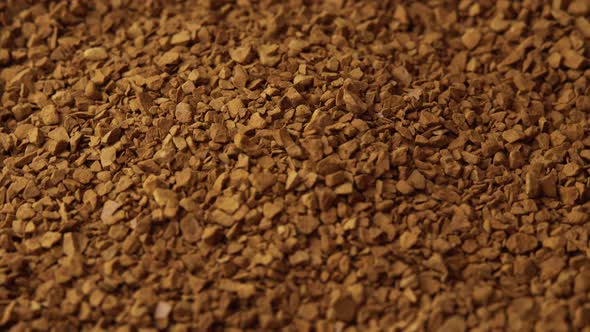 Granules of Instant Coffee Sprinkled on a Plate Closeup Spinning As a Backdground for a Coffee Shop alt