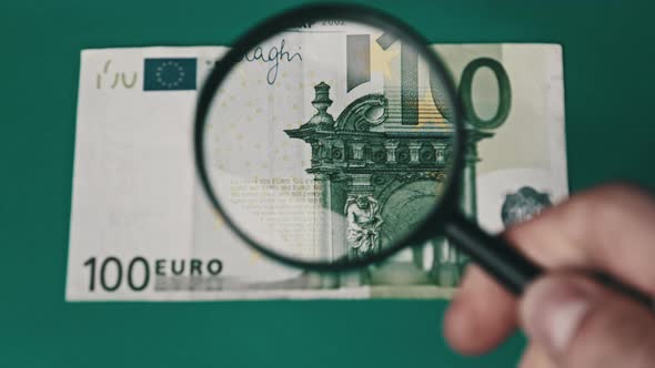 One Hundred Euro Under Magnifying Glass alt
