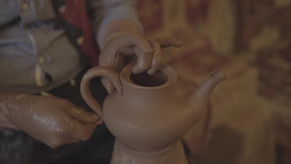 Closeup Front View of Potter's Hands Working and Making Clay with Wet Clay on a Pottery Wheel - 2