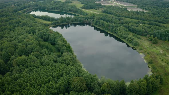 Aerial View of Lakes with Growing Forest Reflection of Sky and Clouds in Water Nature Landscape