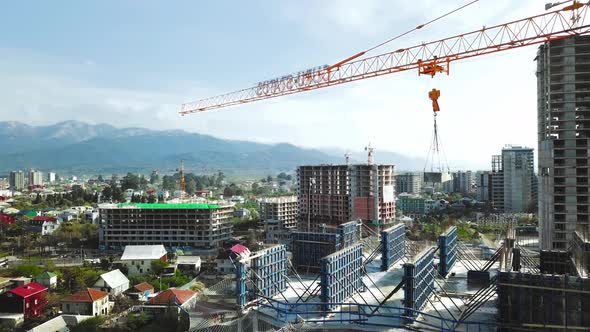 Aerial view of construction site with crane and building. alt