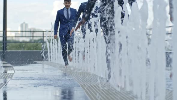 Office Workers Running Through Fountain alt