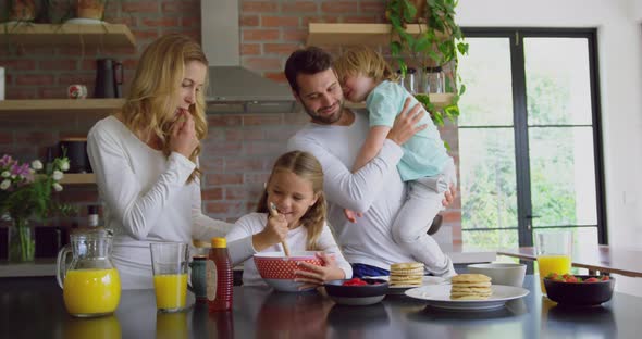 Family preparing food on worktop in kitchen at comfortable home 4k alt