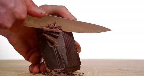 Man Cutting Black Chocolate with Knife, Slow motion 4K alt