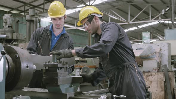 Team engineer working looking report on blueprint, two man planning project. alt