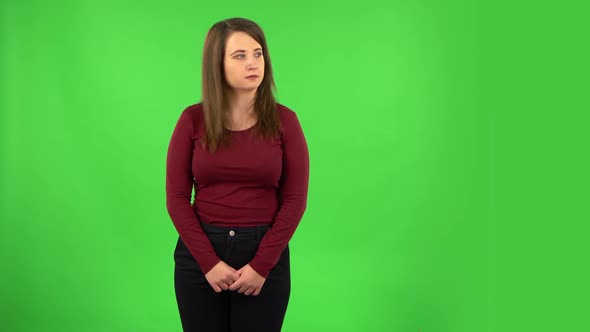 Angry Girl Is Scolding and Threatening with a Fist. Green Screen alt